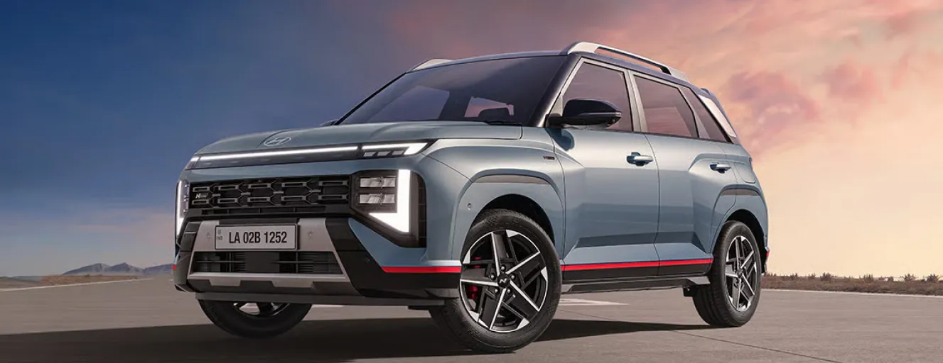 Close-up profile of a gray Hyundai Venue N Line with red accents on the bumper and side skirts.